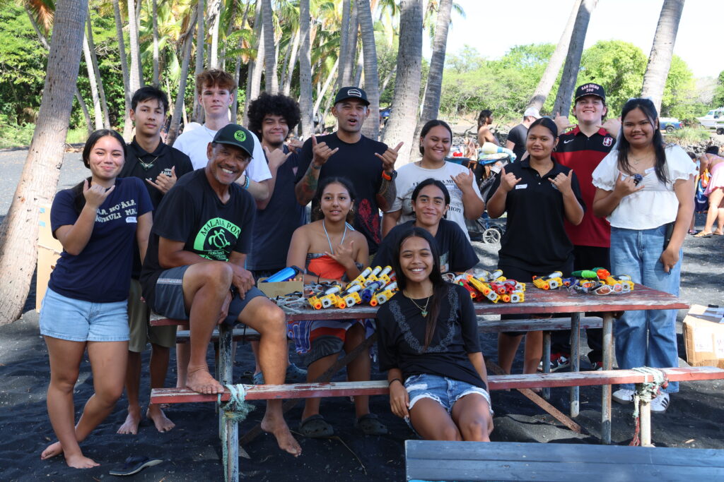 Youth gathered at Punalu'u Black Sand Beach to learn about the power of community organizing and collaboration with Guy Enriques. Credit: Jennifer Makuakane