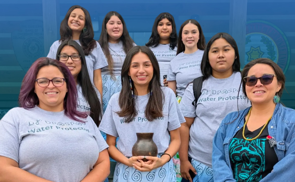 Junior NAIWA Daughters stand with the Longperson before the Eastern Band of Cherokee Council. Back row (Janée Smith, Zailiana Blythe, Laila Crowe-Taylor, Misha Slee) Second Row (Kyndra Postoak, Marijane Tafoya) Front Row (Kimberly Smith-Mentor, Jasmine Smith, Malia Crowe-Mentor)